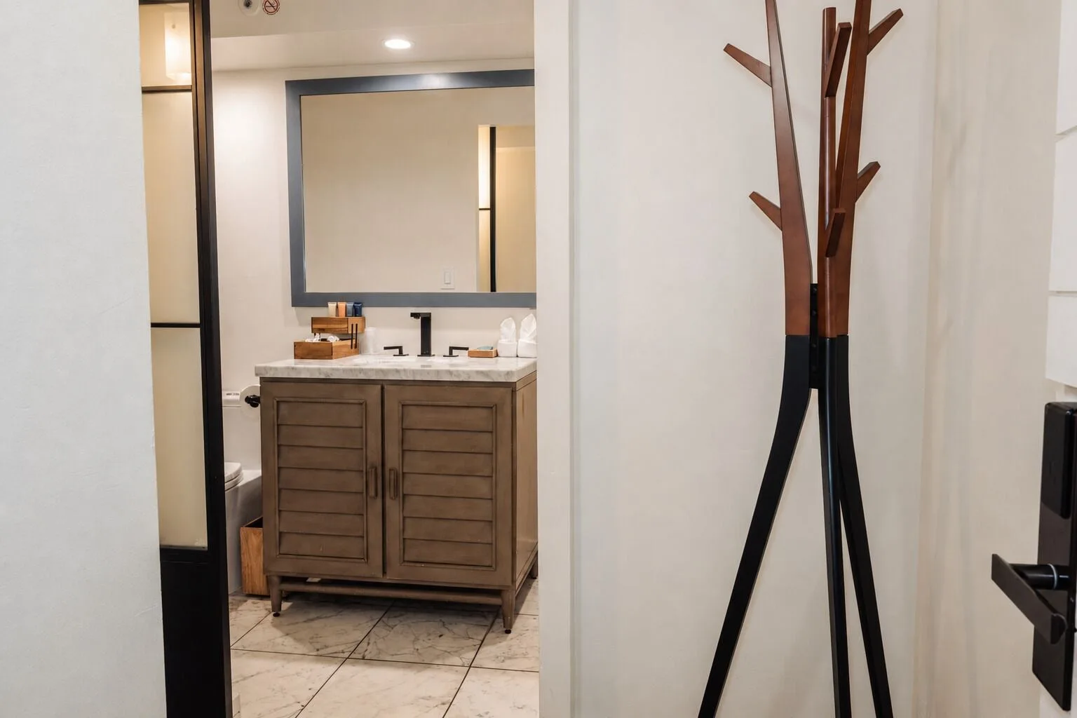 Penthouse Hoku Terrace ADA entry with bathroom vanity and coat stand at Hotel La Croix.