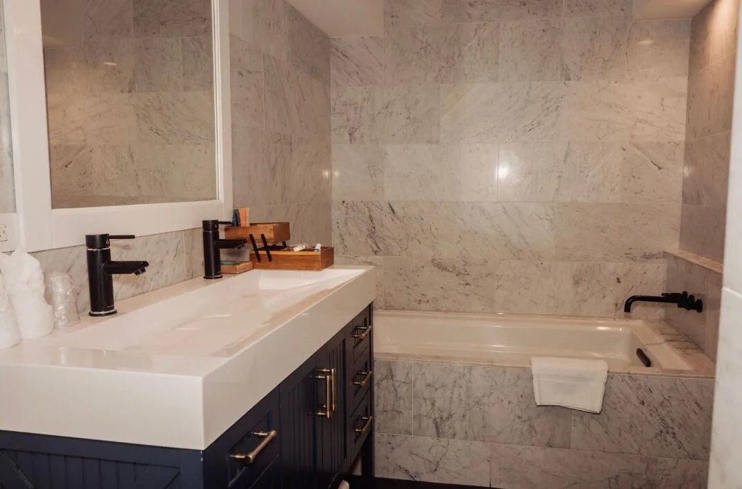 Penthouse Hoku Terrace bathroom at Hotel La Croix with vanity, marble tile and soaking tub.