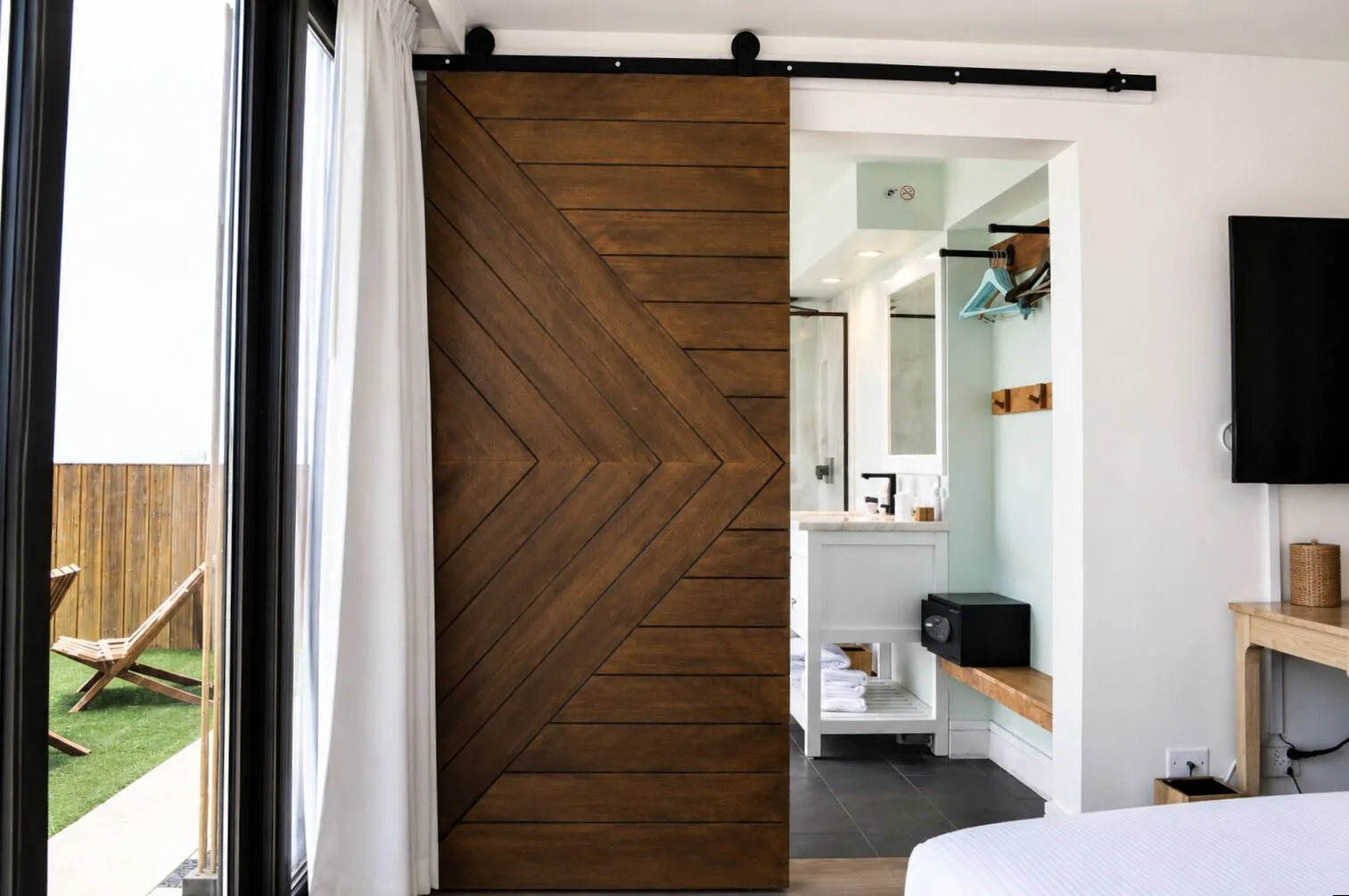 Penthouse Hoku Terrace Oceanview room with terrace doors and bathroom entry at Hotel La Croix.