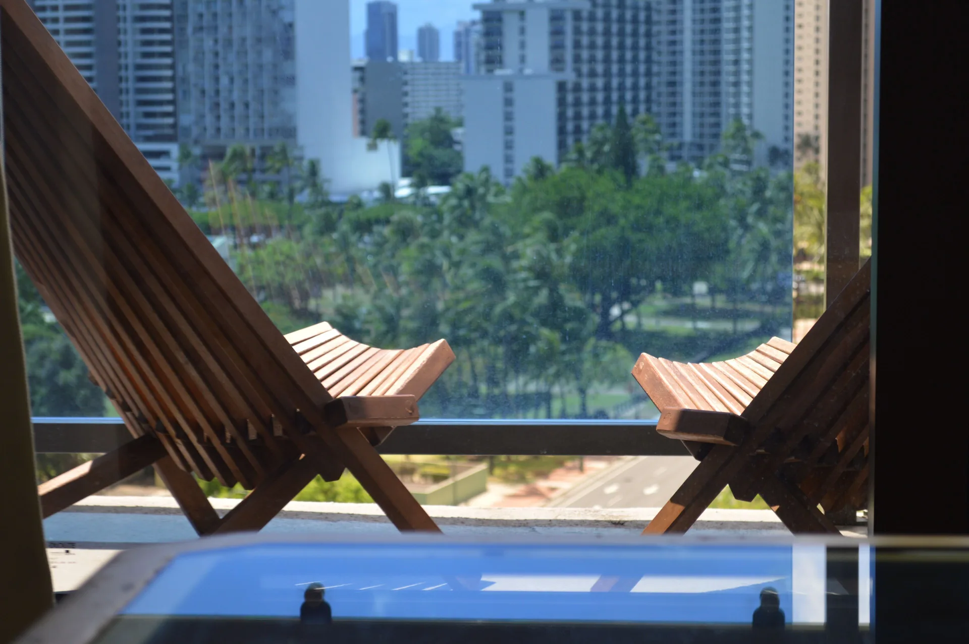 Lanai chairs overlook Waikiki high-rises from a Premium Kalakaua Haus room at Hotel La Croix.
