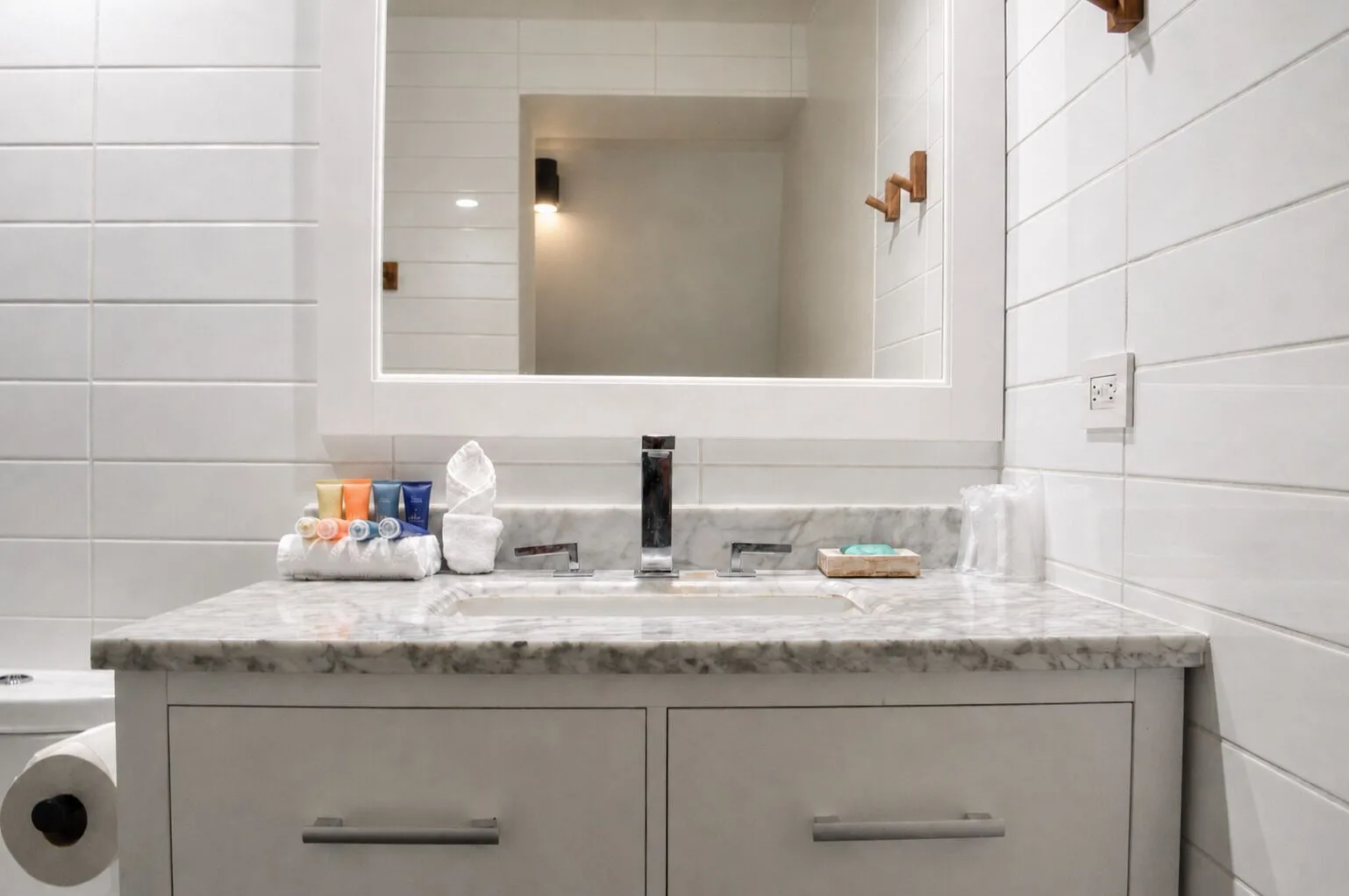 Premium Kalakaua Haus bathroom vanity with mirror and marble counter at Hotel La Croix.
