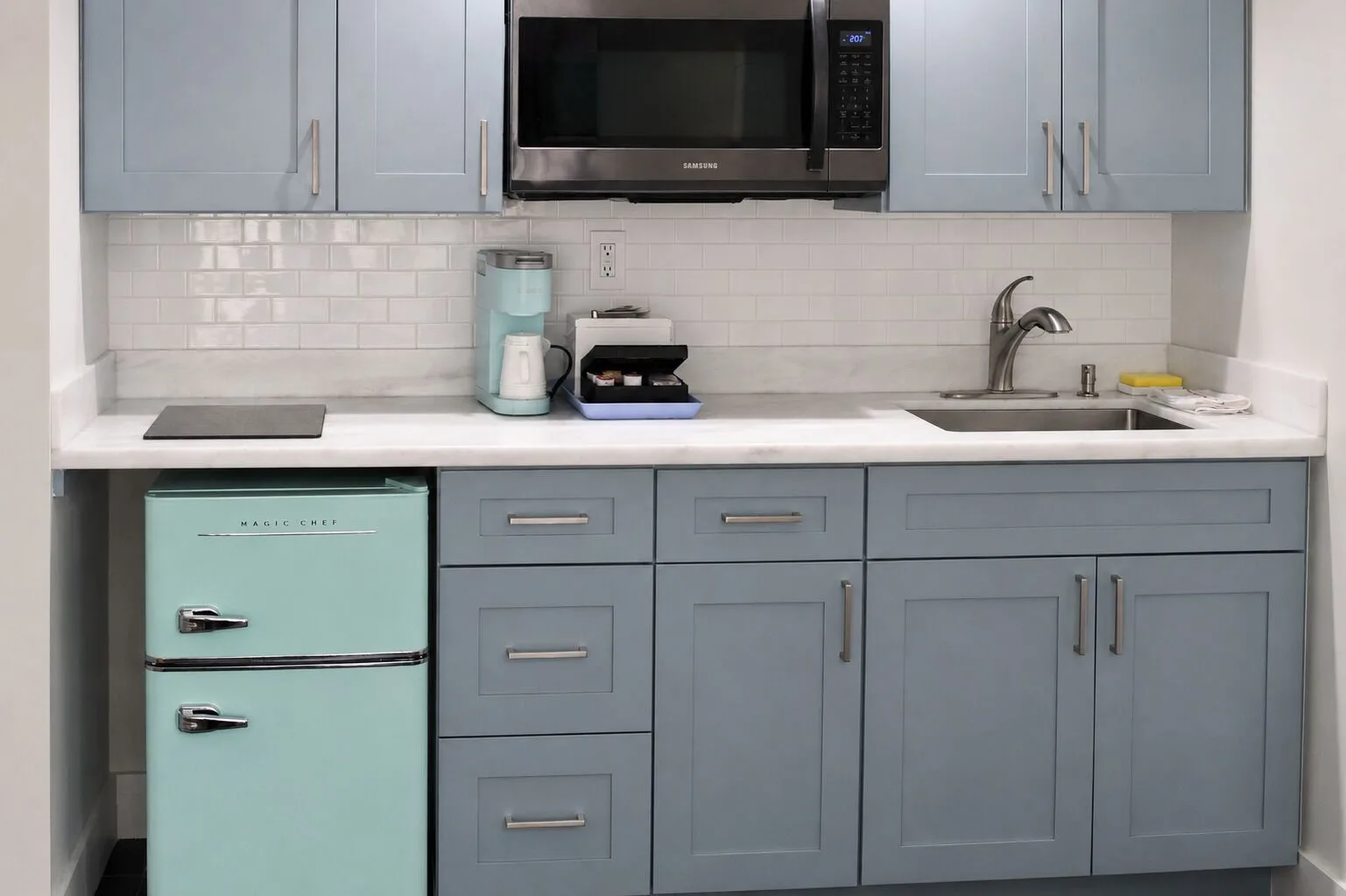 Premium Kalakaua Haus Kitchenette cabinets, sink, microwave and mini fridge at Hotel La Croix.