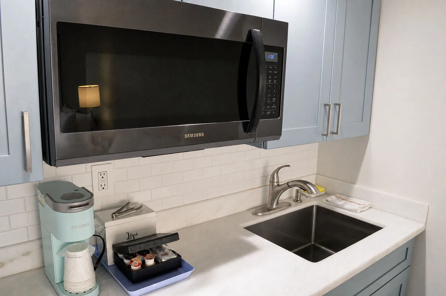 Premium Kalakaua Haus Kitchenette counter with microwave, sink, and coffee maker at Hotel La Croix.