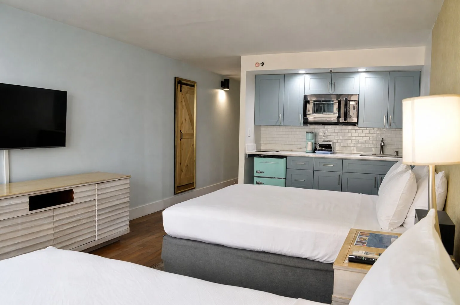 Premium Kalakaua Haus Kitchenette room with beds, TV, dresser and kitchenette at Hotel La Croix.