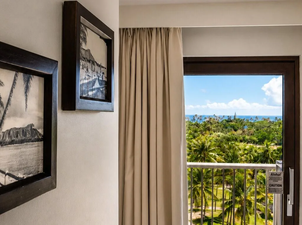 Premium Kalakaua Haus Oceanview room lanai doorway with palm and ocean view at Hotel La Croix.