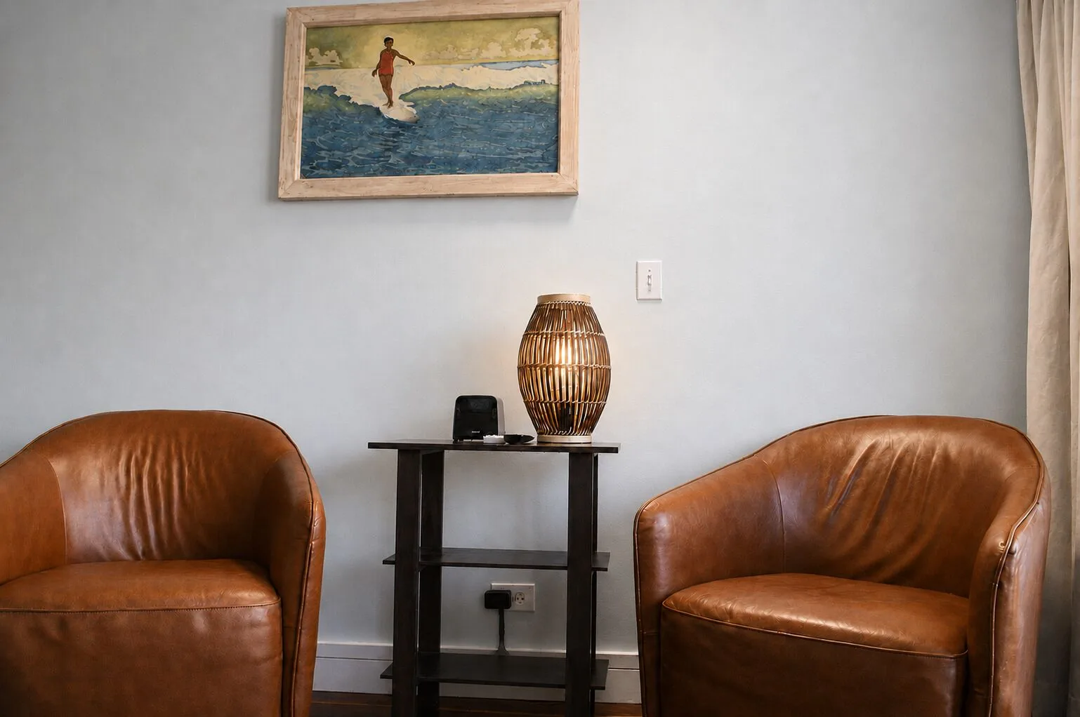 Two leather chairs and side table in a Premium Kalakaua Haus room at Hotel La Croix.