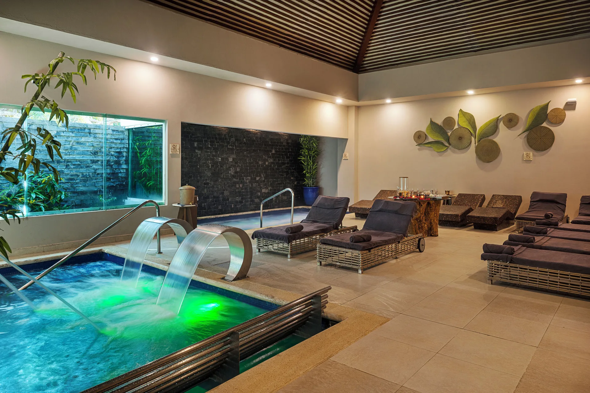An indoor hydrotherapy pool and lounge area at Hotel Marina El Cid Spa & Beach Resort.