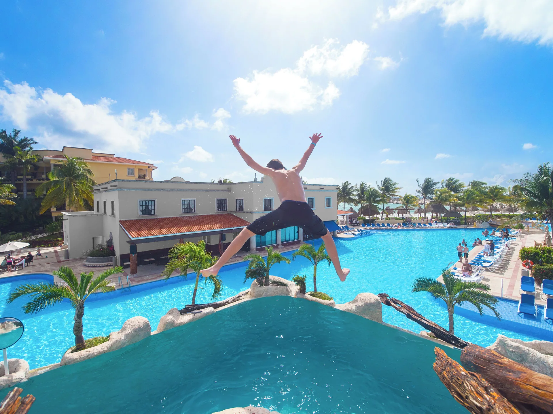 Guest jumps into the pool area at Hotel Marina El Cid Spa & Beach Resort.