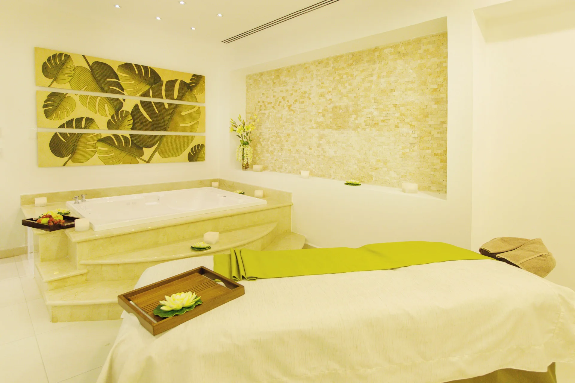 Spa treatment bed and soaking tub at Hotel Marina El Cid Spa & Beach Resort.