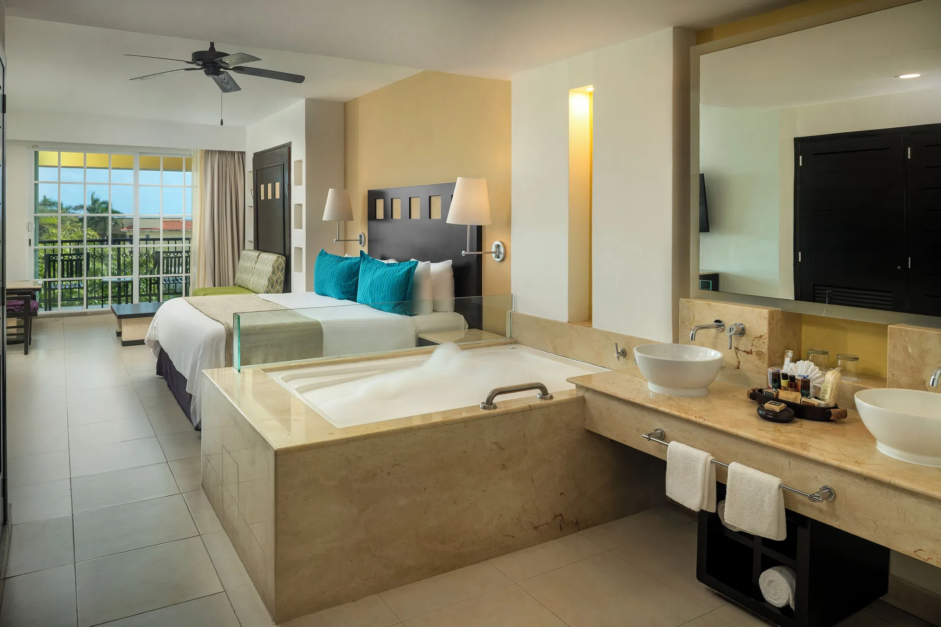 Junior Suite with Jacuzzi, king bed and vanity at Hotel Marina El Cid Spa & Beach Resort.