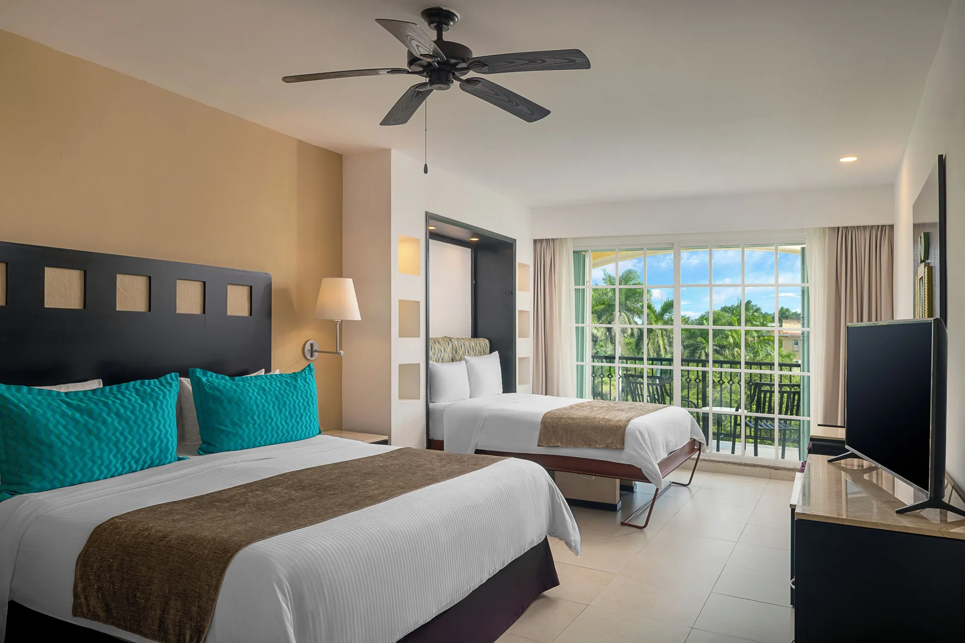 Junior Suite with two beds and balcony view at Hotel Marina El Cid Spa & Beach Resort.