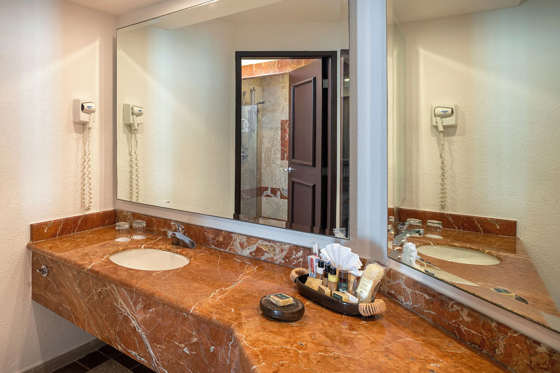 Luxury Room bathroom vanity with marble counter at Hotel Marina El Cid Spa & Beach Resort.