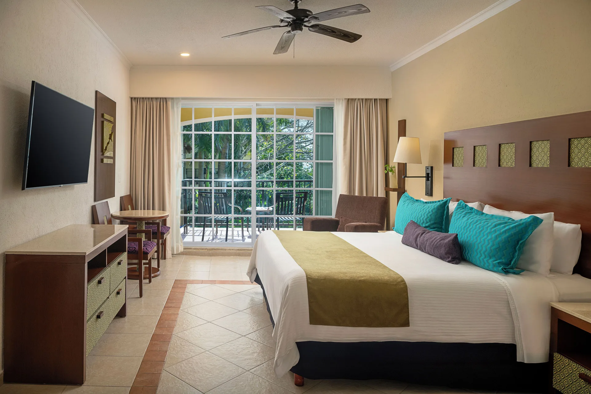 Luxury Room with king bed and balcony doors at Hotel Marina El Cid Spa & Beach Resort.