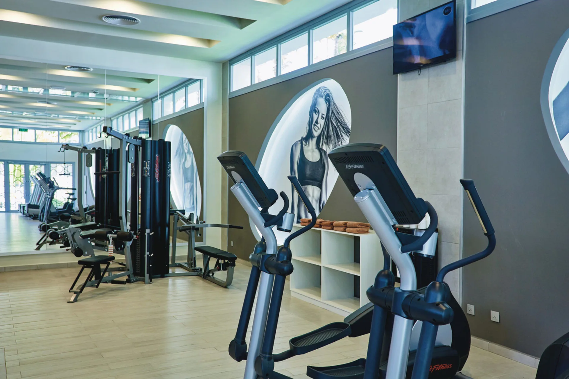 Fitness center with cardio machines and weight equipment at Hotel Riu Bambu.