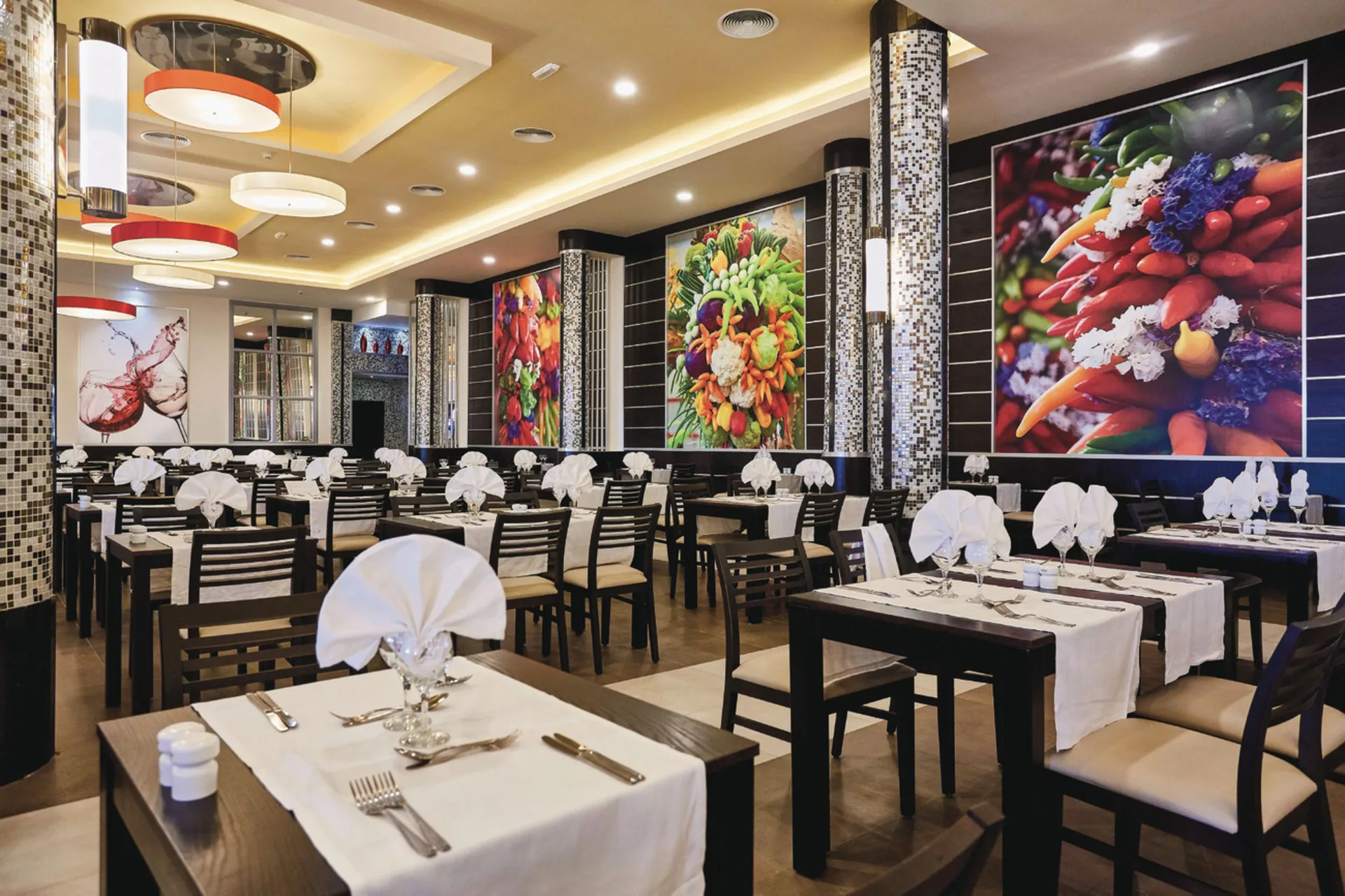 International buffet dining room with produce wall art at Hotel Riu Bambu.