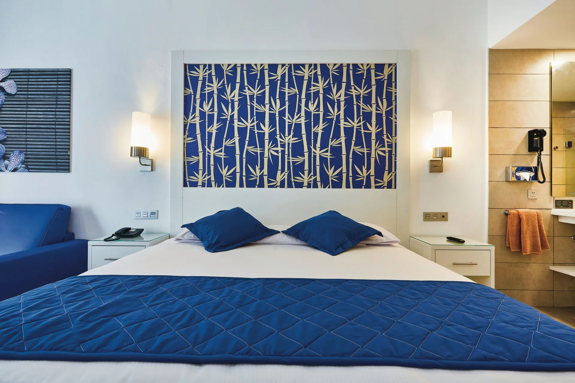 Family Room bed and open bathroom area at Hotel Riu Bambu.