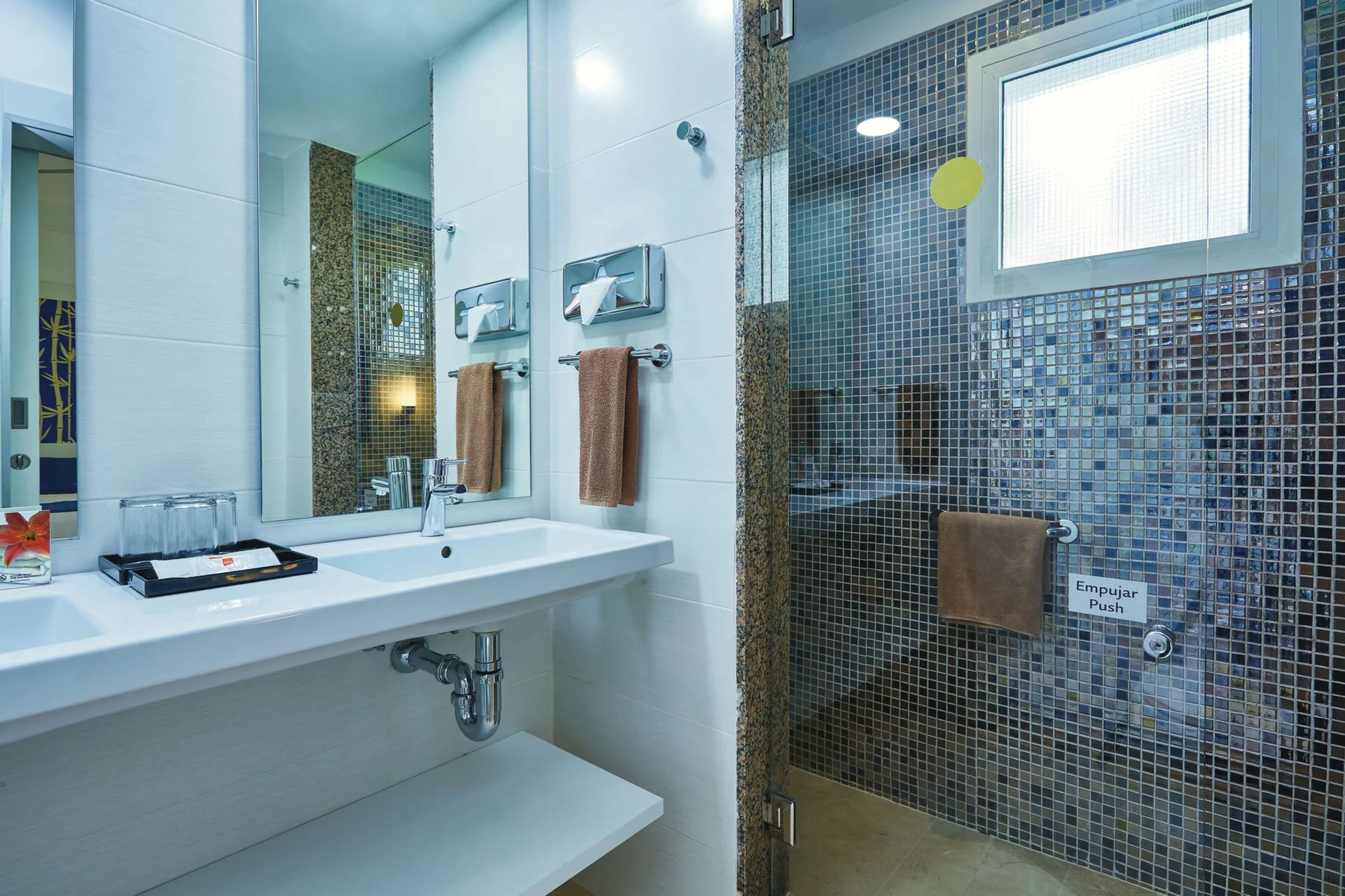 Family Room bathroom with double sink vanity and glass shower at Hotel Riu Bambu.