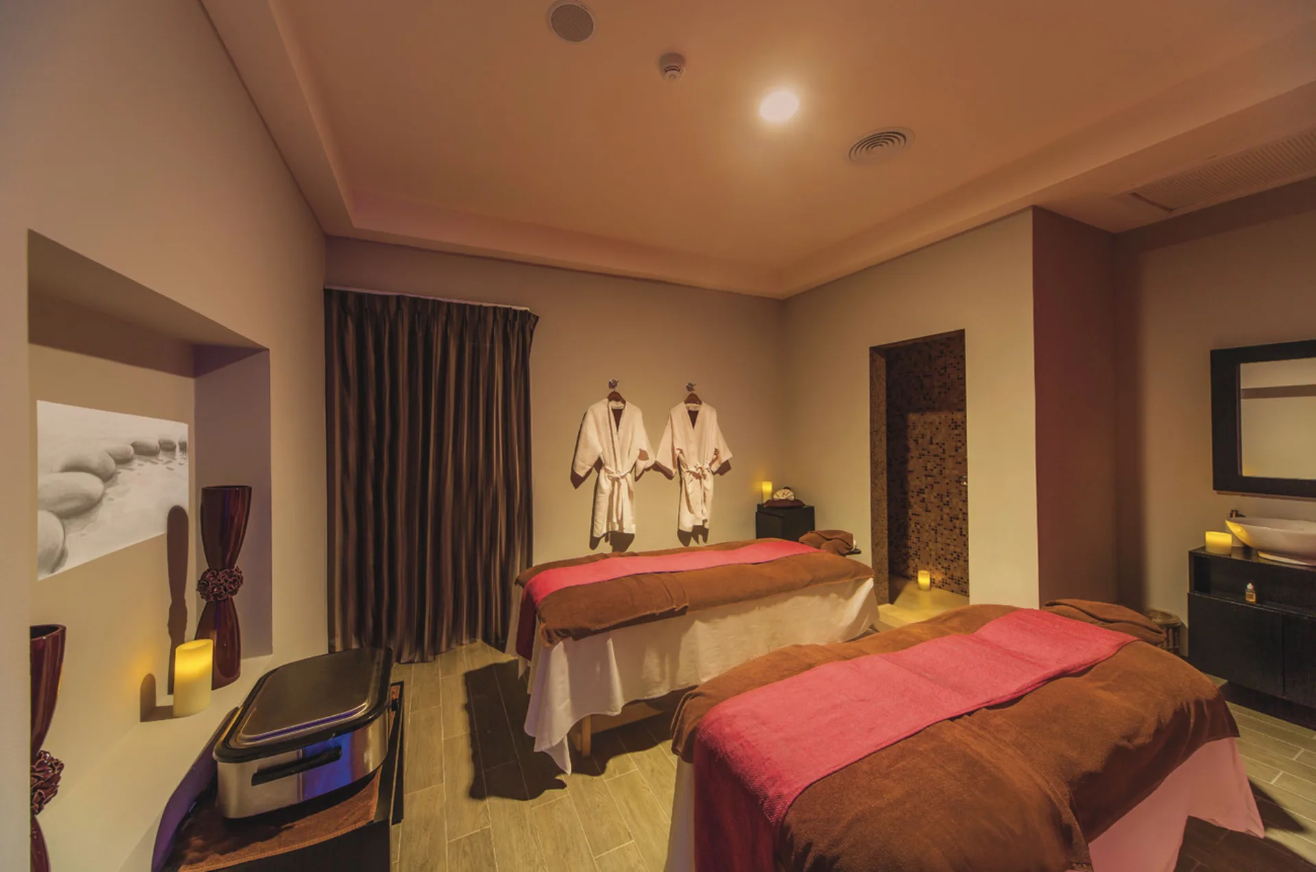 Spa treatment room with two massage tables at Hotel Riu Cancun.