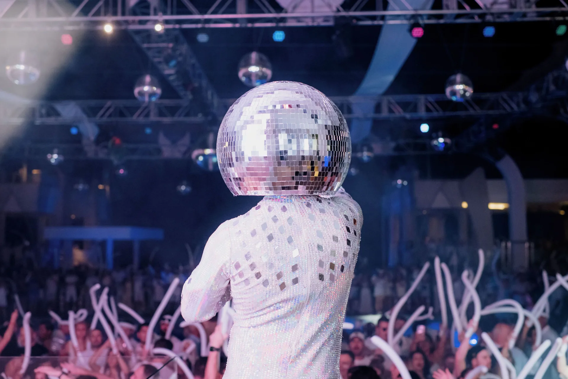 Disco-ball performer facing a party crowd at Hotel Riu Cancun.