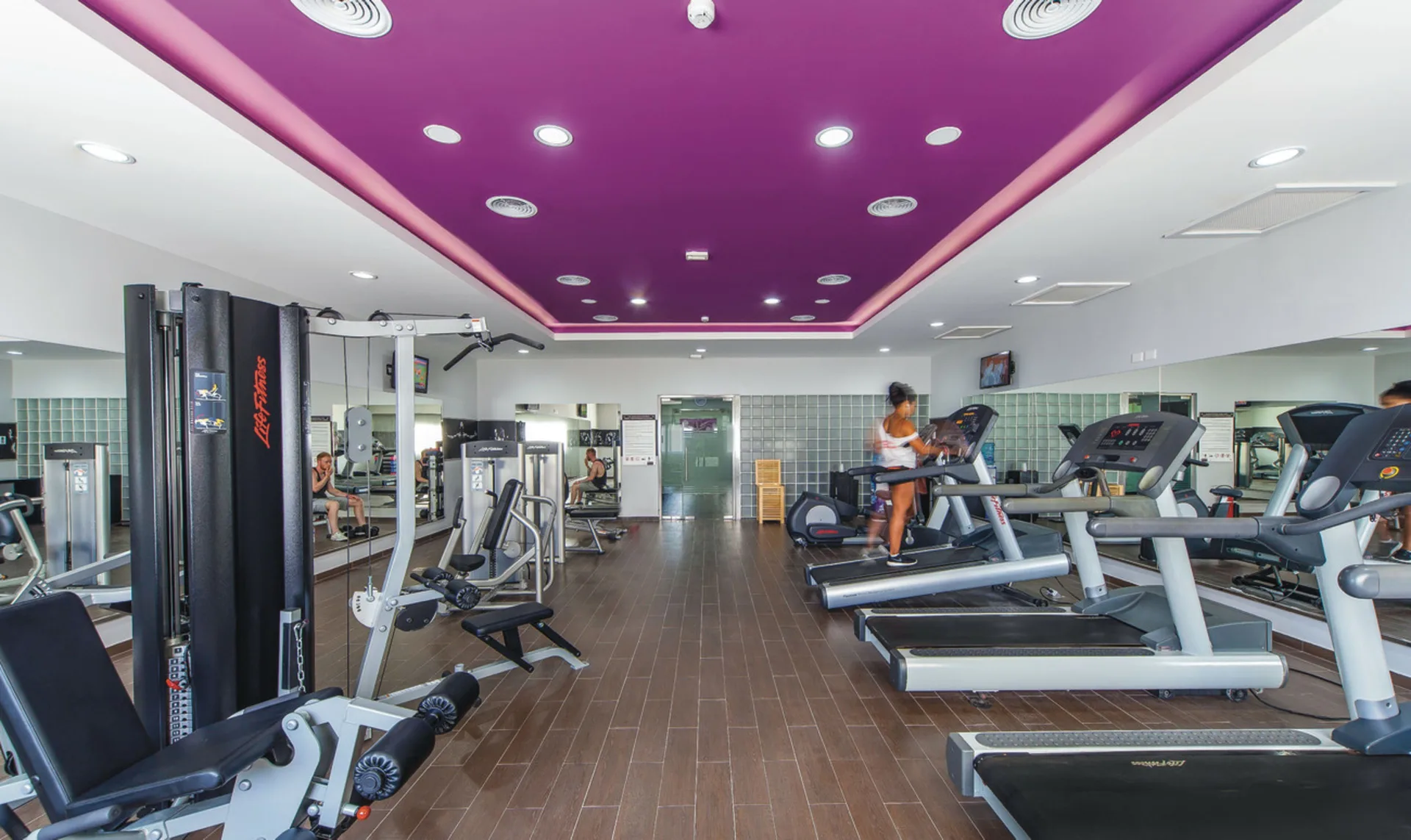 Fitness center with treadmills and weight machines at Hotel Riu Cancun.