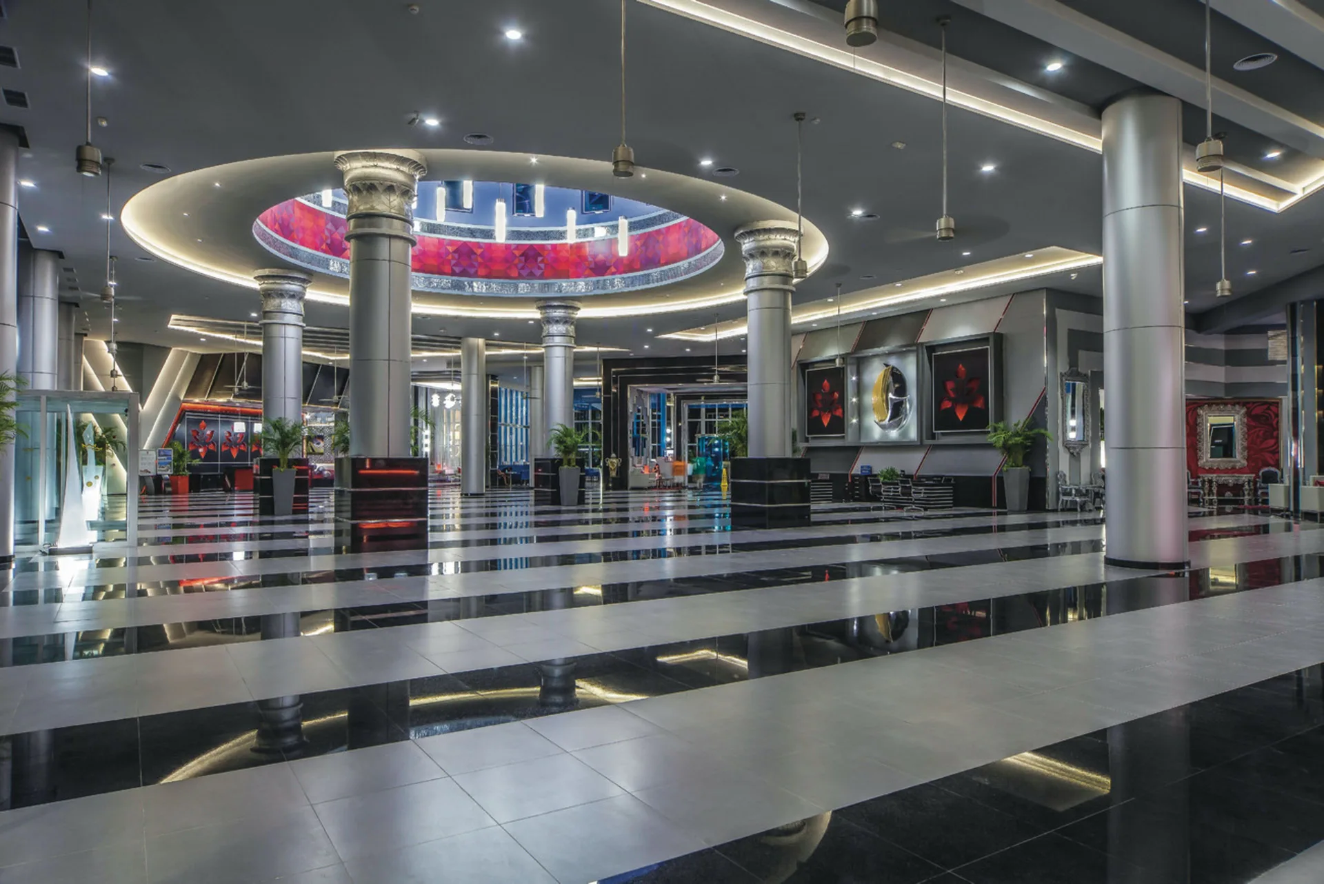 Modern lobby with striped floors and round ceiling feature at Hotel Riu Cancun.