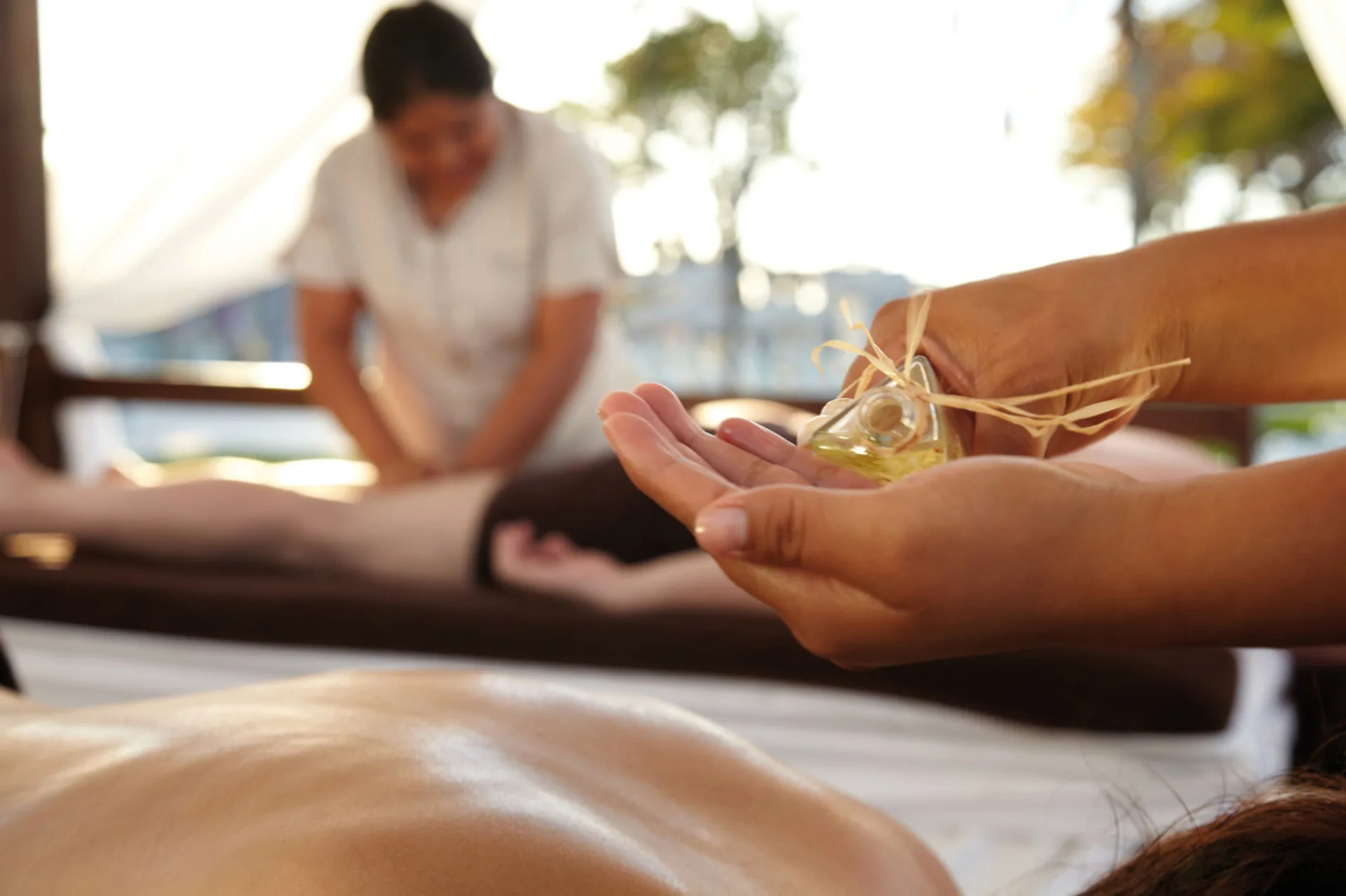 Massage oil being held during a spa treatment at Hotel Riu Cancun.