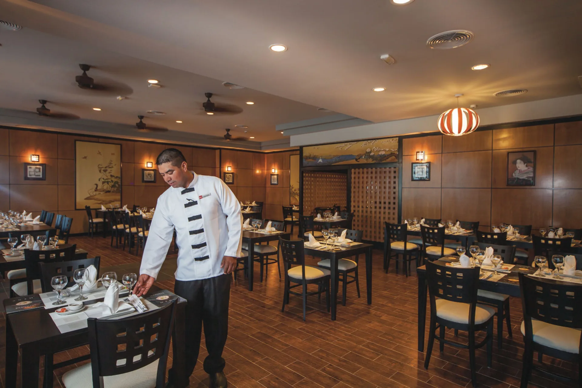 Asian-style restaurant dining room with set tables at Hotel Riu Cancun.