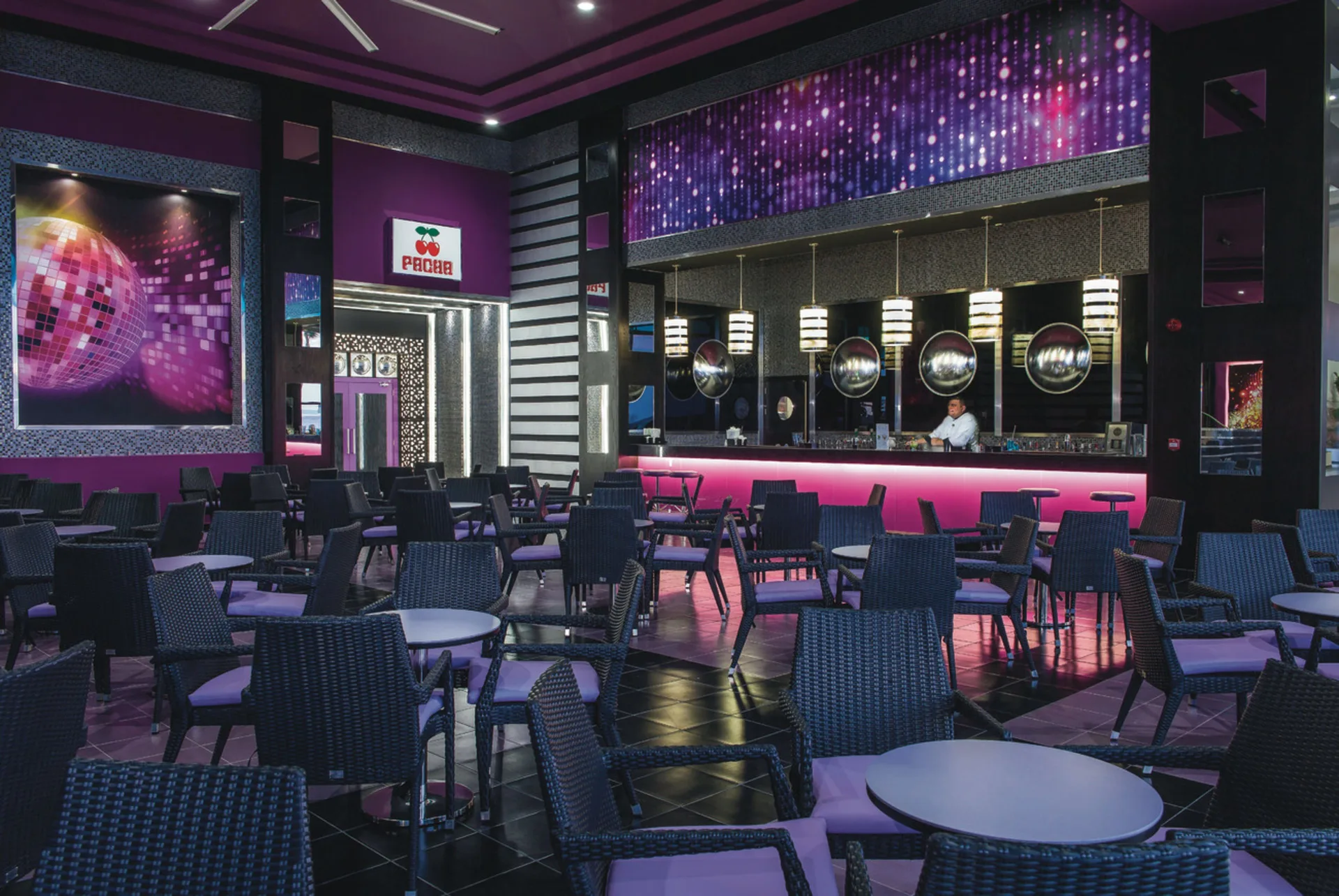 Pacha lounge seating and pink-lit bar at Hotel Riu Cancun.