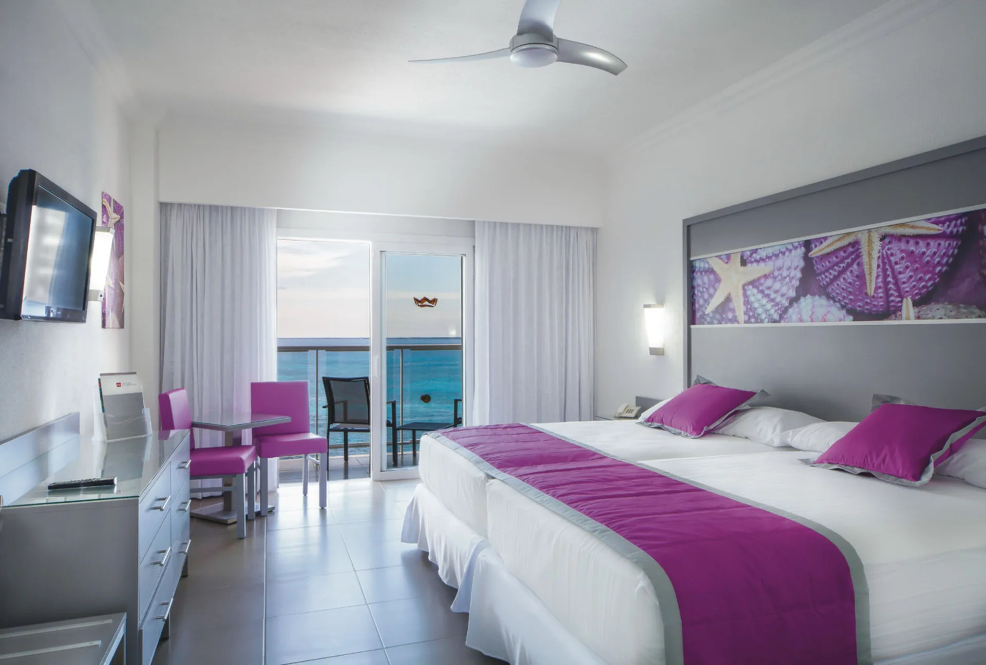 Standard Ocean View room with two beds and balcony at Hotel Riu Cancun.