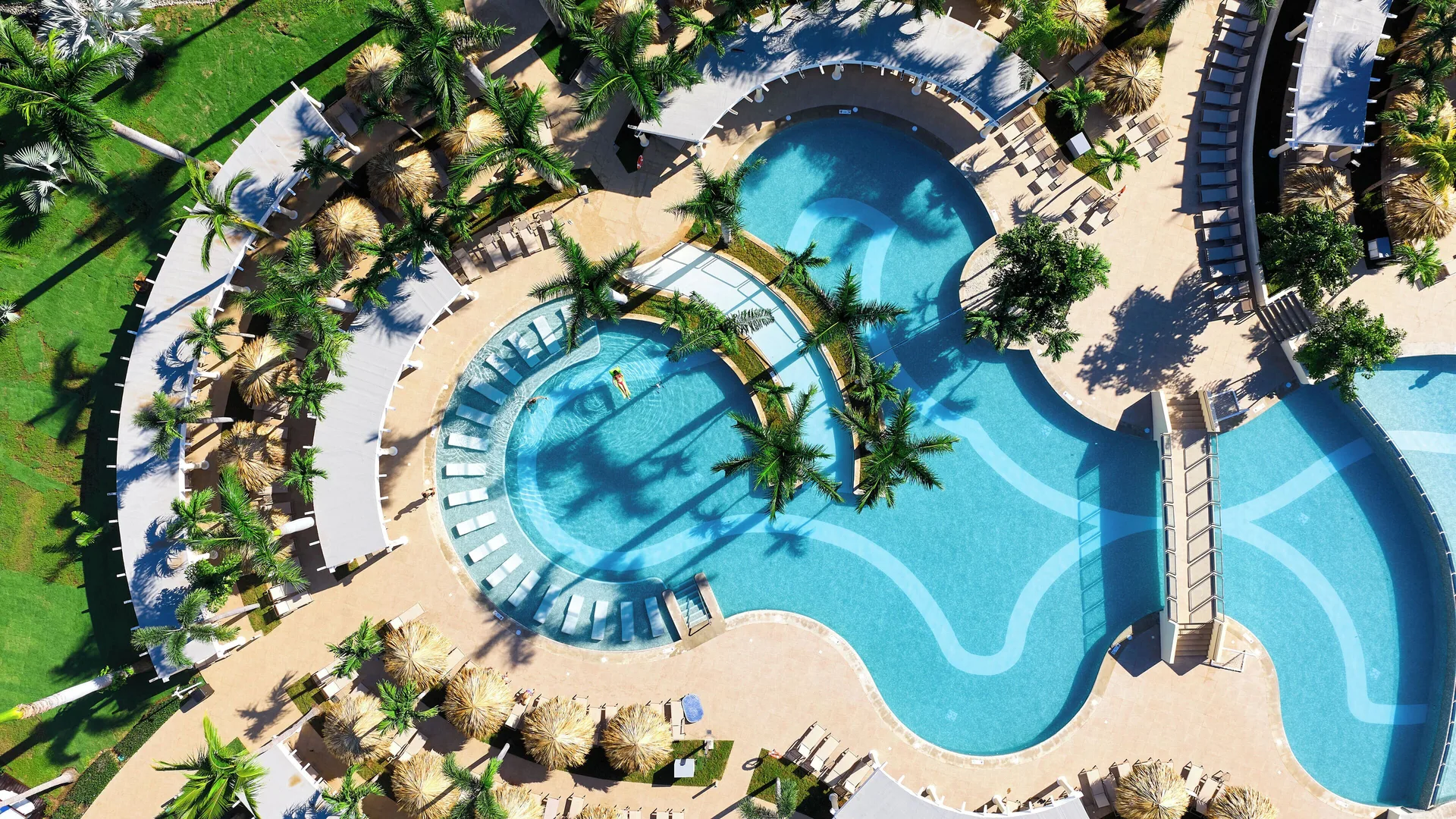 Aerial view of curving pools, palms and sun decks at Hotel Riu Guanacaste.