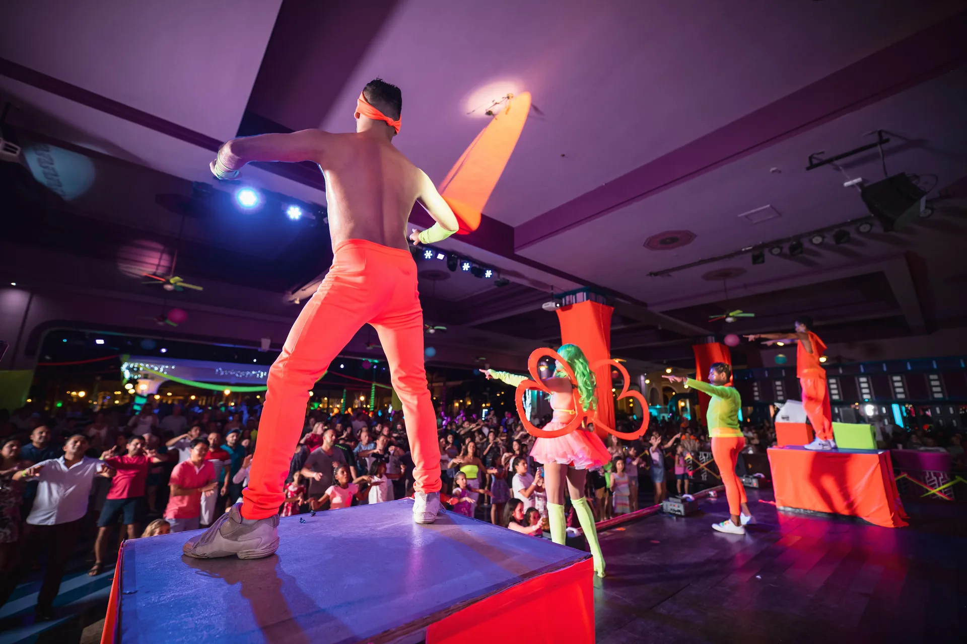 Entertainers lead guests from raised platforms at Hotel Riu Guanacaste.