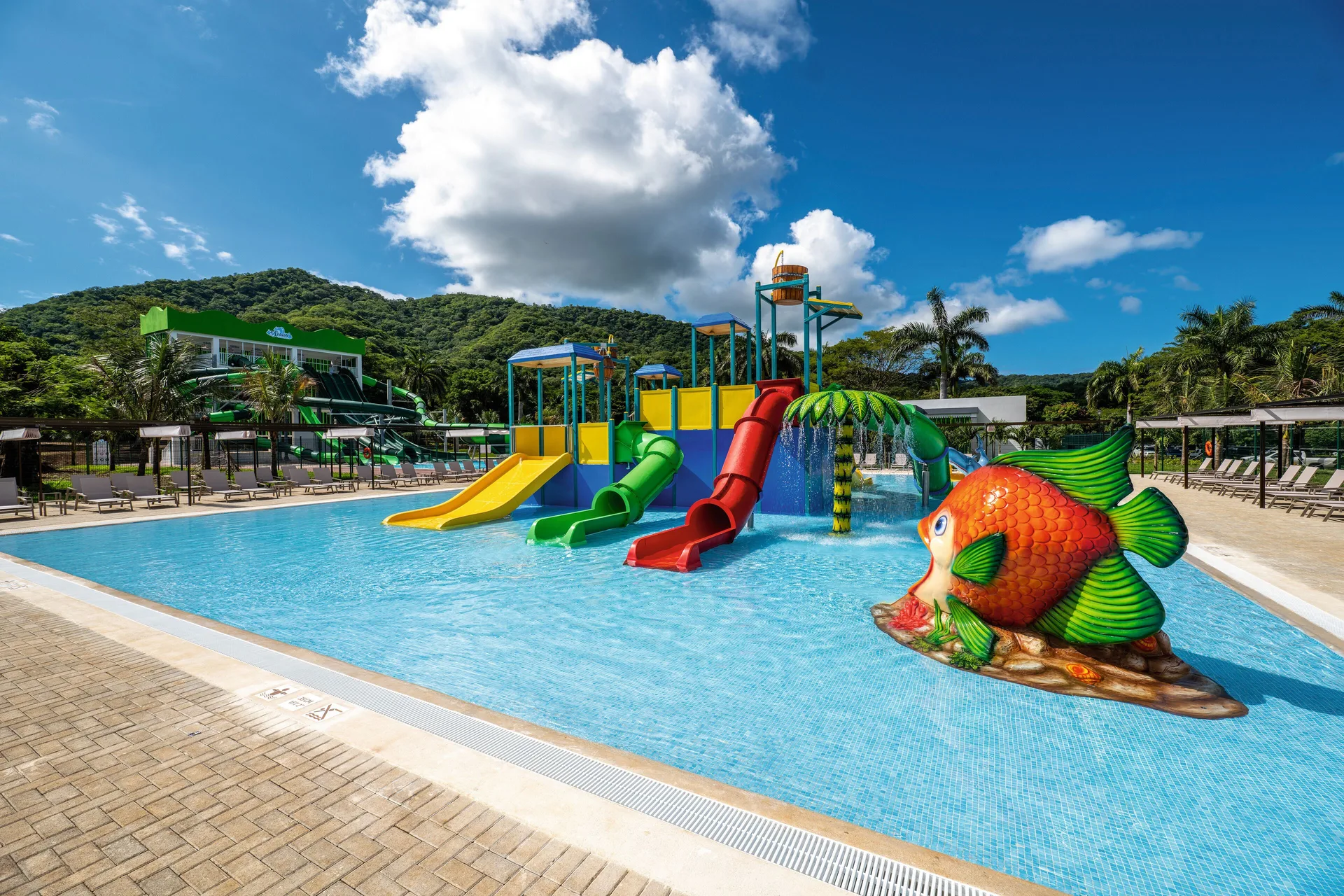 Fish figure and colorful children's slides in the pool at Hotel Riu Guanacaste.