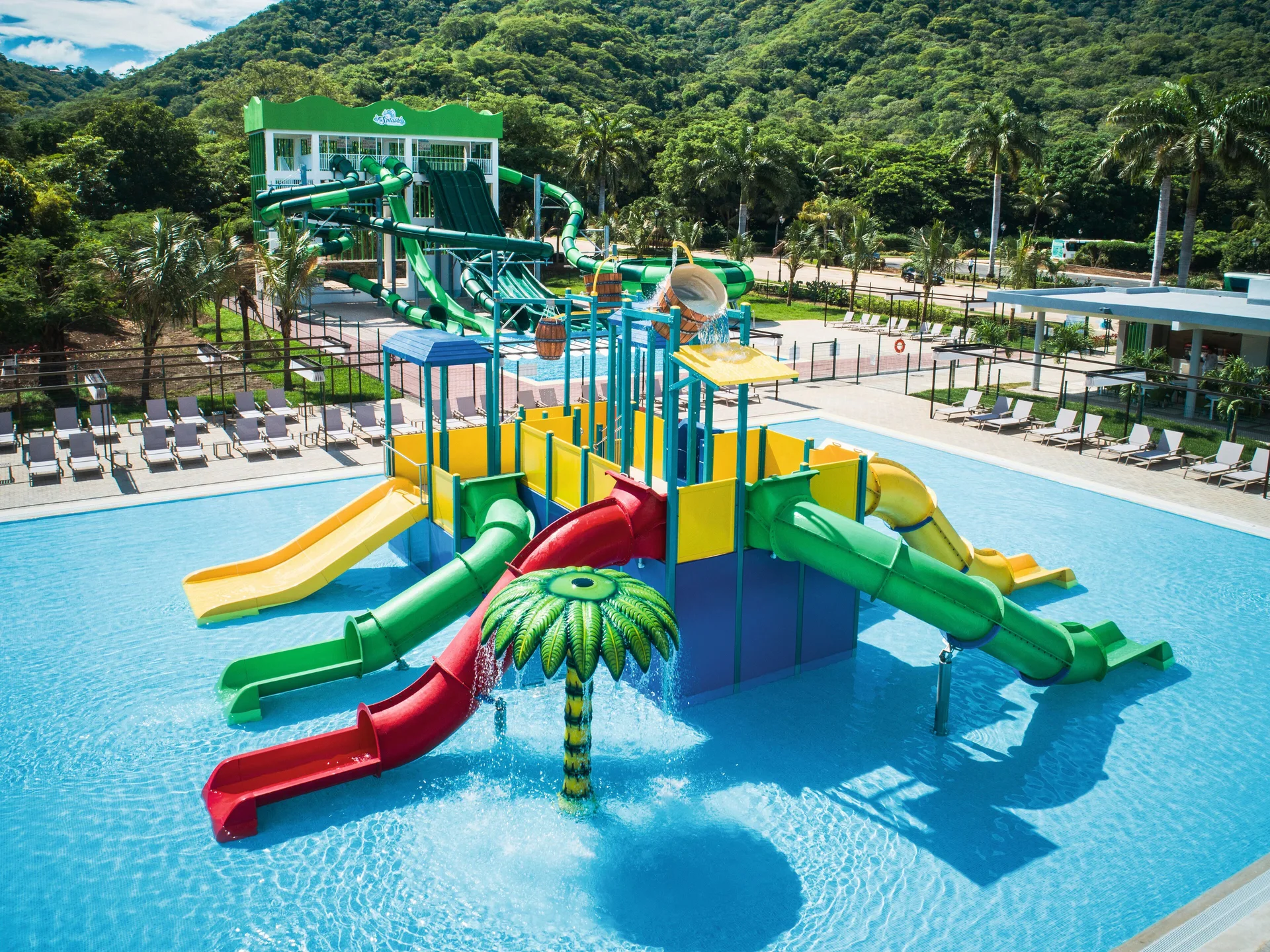 Children's splash pool with colorful slides at Hotel Riu Guanacaste.