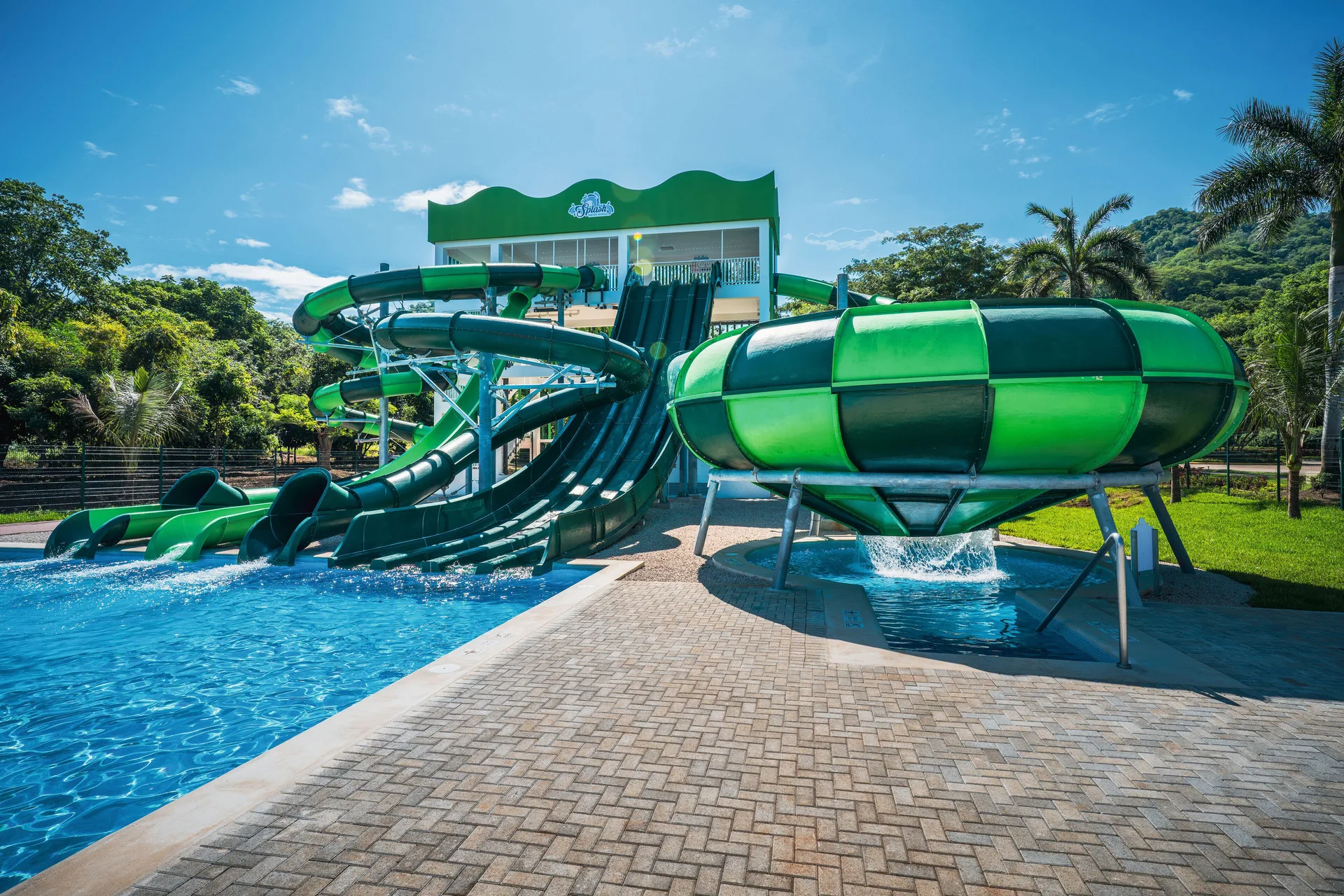 Green water slides and bowl slide beside the pool at Hotel Riu Guanacaste.