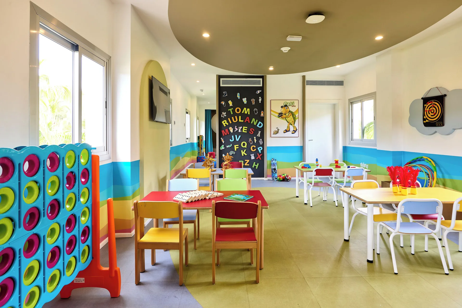 Kids activity room with game tables and large connect-four at Hotel Riu Guanacaste.