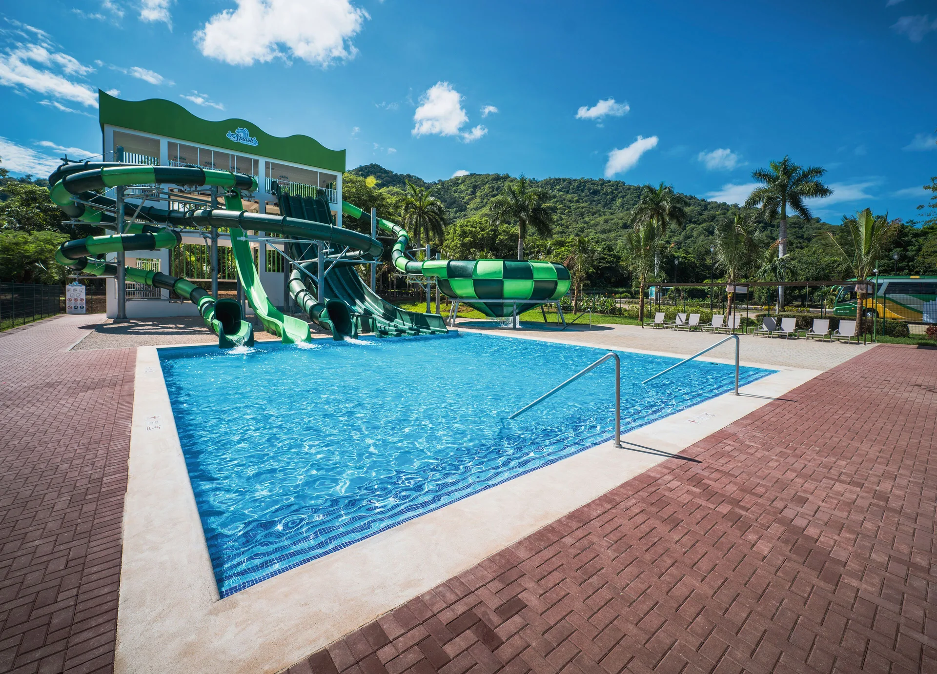 Main slide pool with green water slides at Hotel Riu Guanacaste.