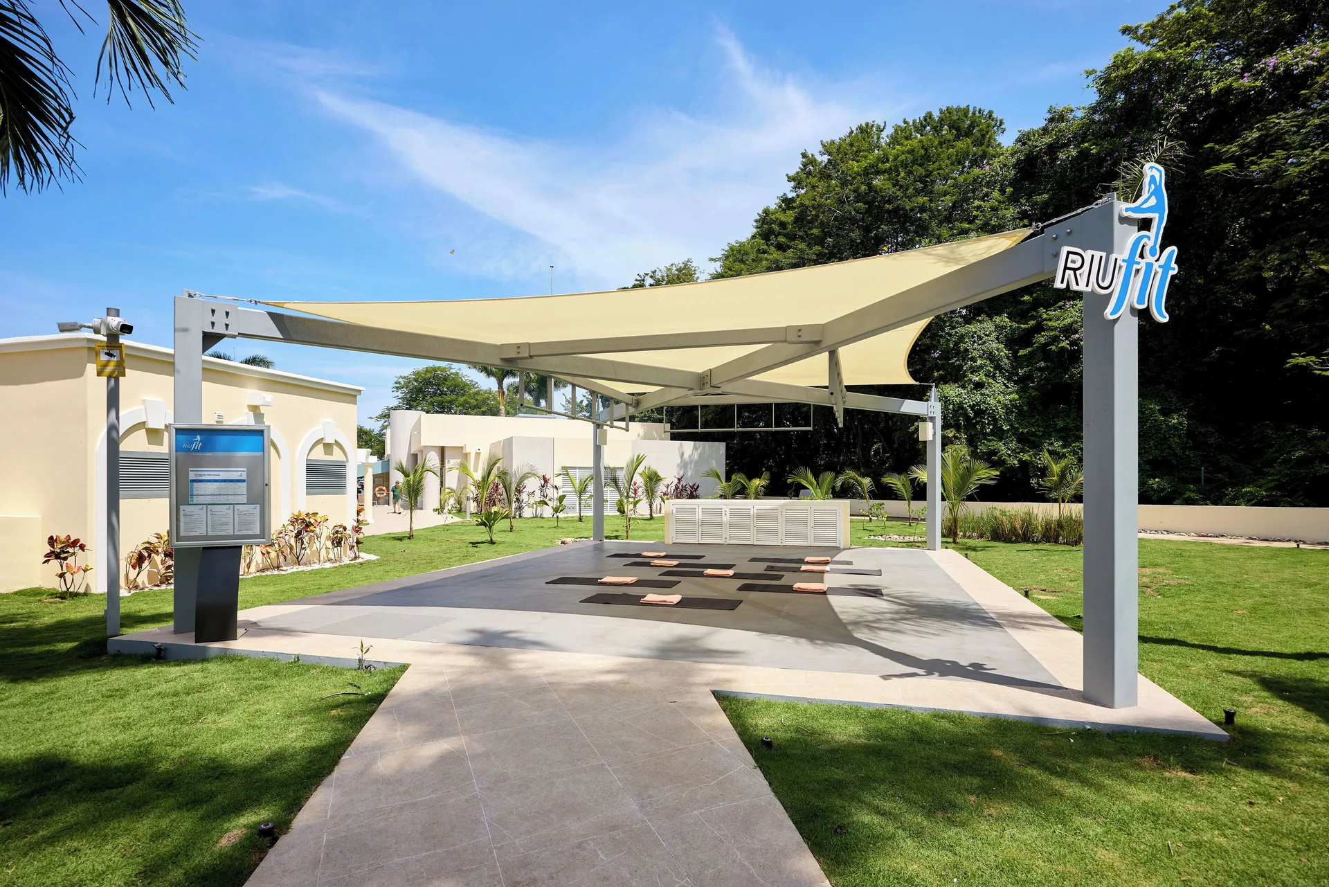 Outdoor fitness deck with shade canopy and exercise mats at Hotel Riu Guanacaste.