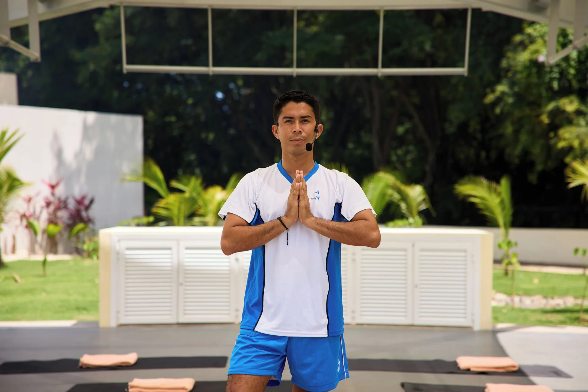 Fitness instructor standing on an outdoor exercise deck at Hotel Riu Guanacaste.