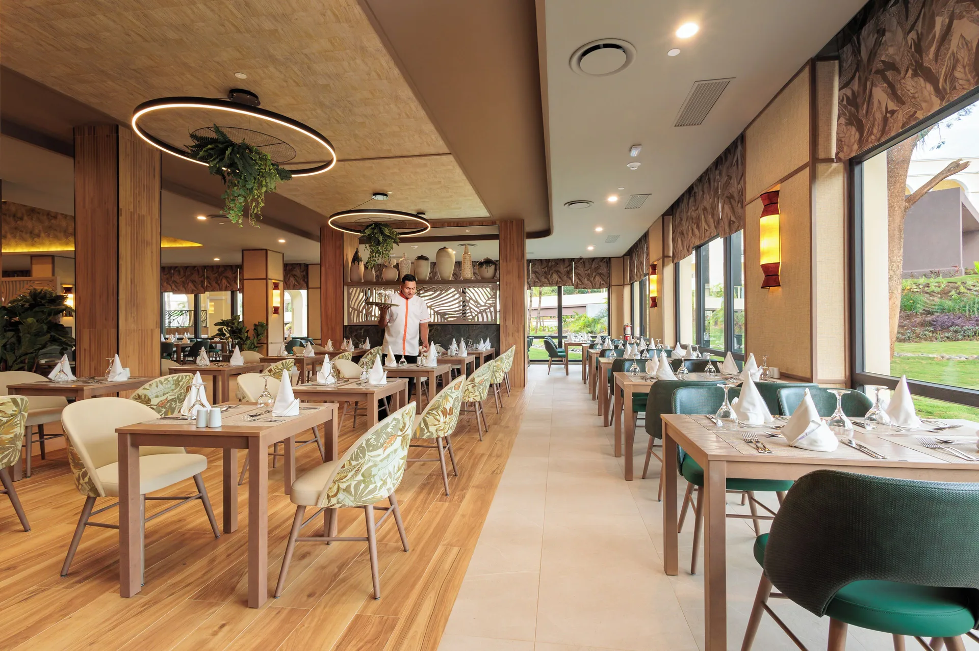 Leaf-pattern restaurant dining room with garden windows at Hotel Riu Guanacaste.
