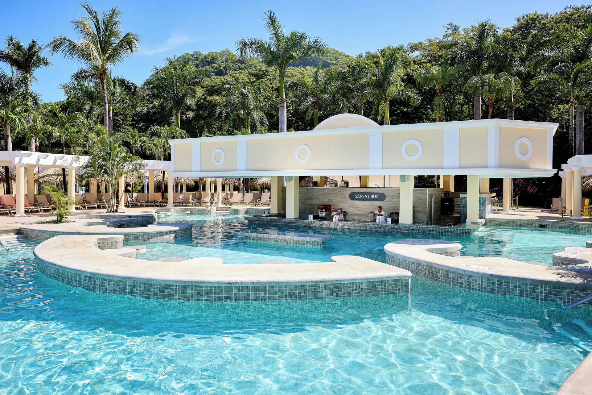 Santa Cruz swim-up bar surrounded by pool water at Hotel Riu Guanacaste.