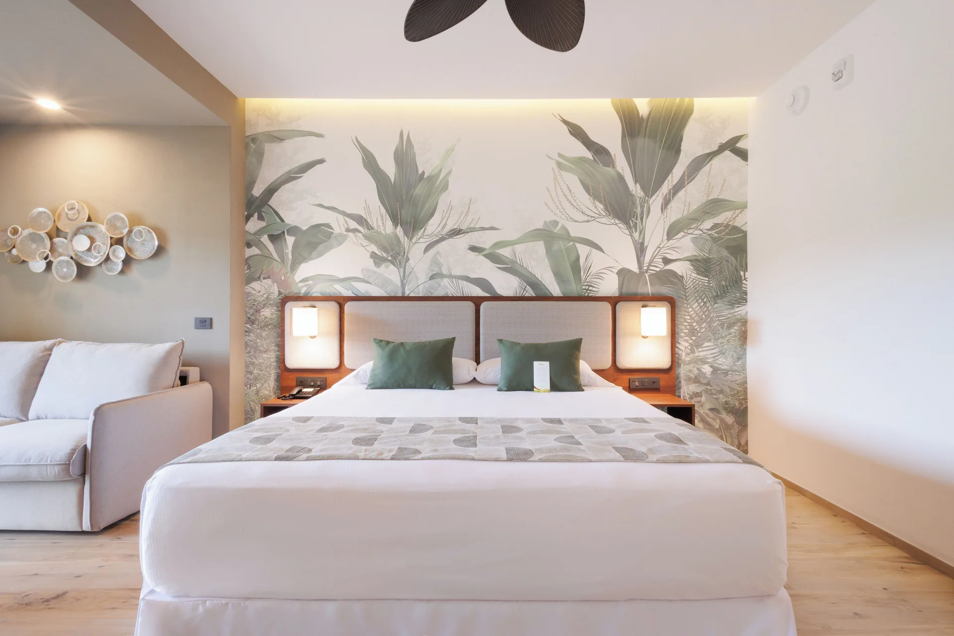 Deluxe Room Pool View bed with botanical mural at Hotel Riu Guanacaste.