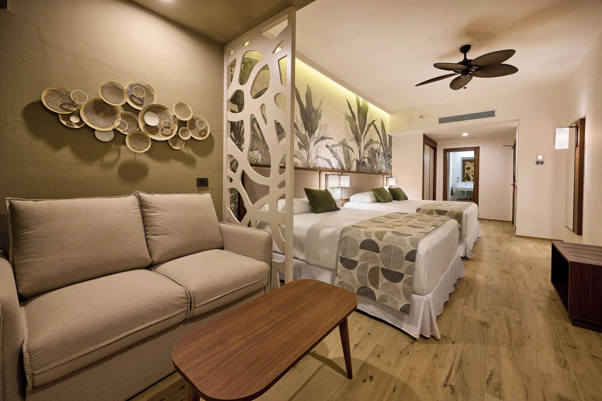 Family Room with twin beds and sofa at Hotel Riu Guanacaste.