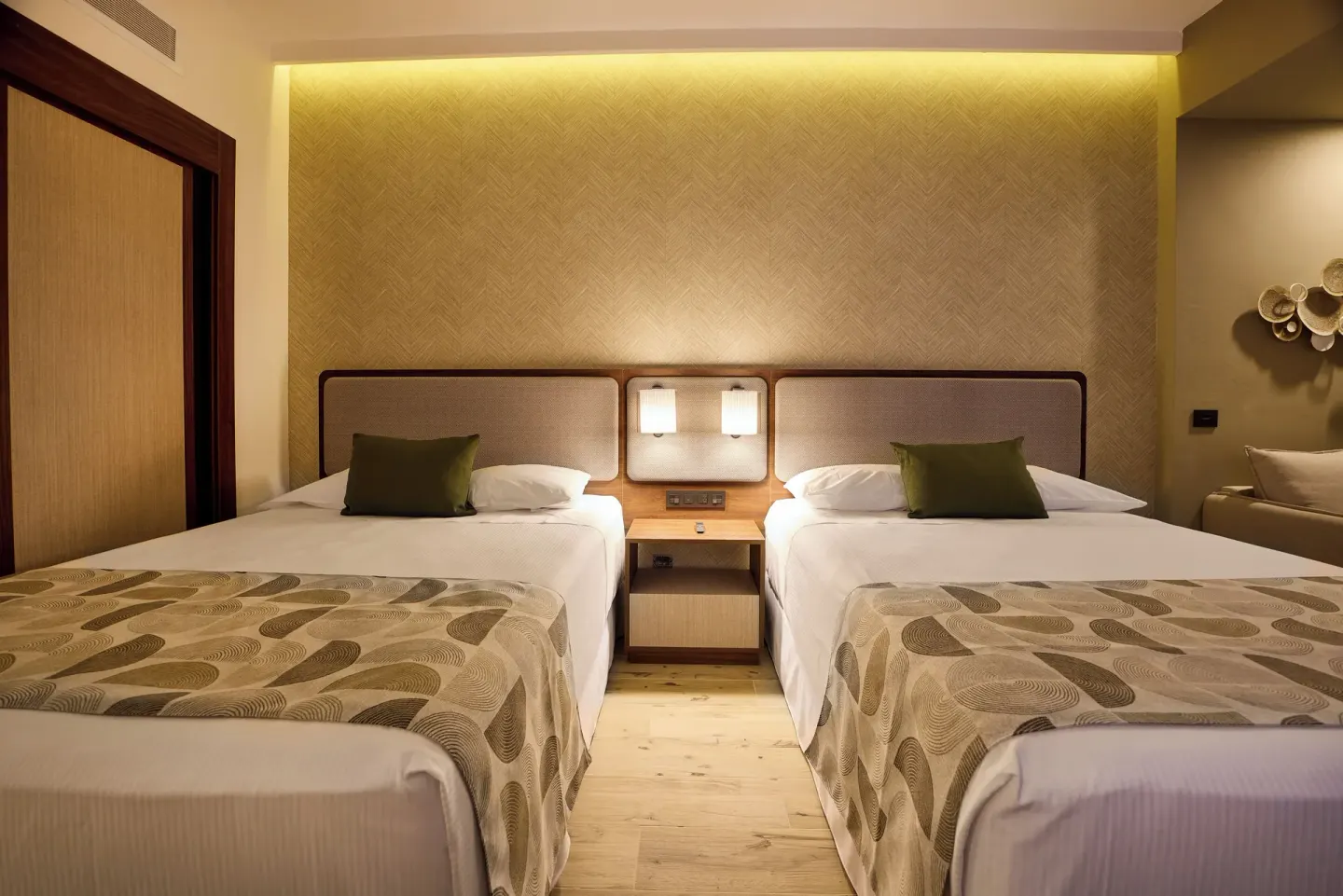 Family Suite second bedroom with two beds and central nightstand at Hotel Riu Guanacaste.