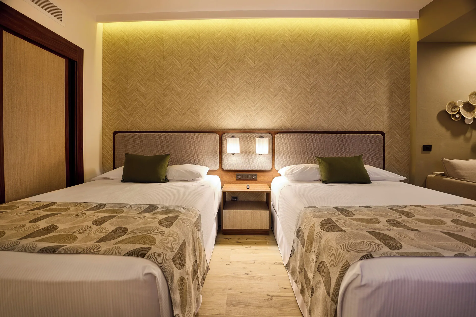 Family Suite second bedroom with two beds and central nightstand at Hotel Riu Guanacaste.