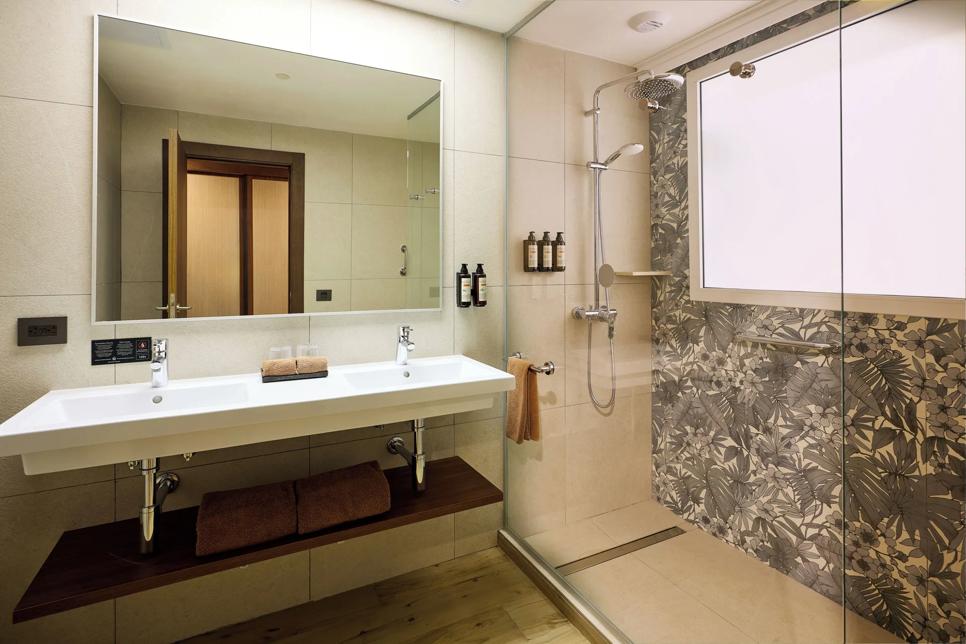 Swim-up adults-only room bathroom with double sink and shower at Hotel Riu Guanacaste.