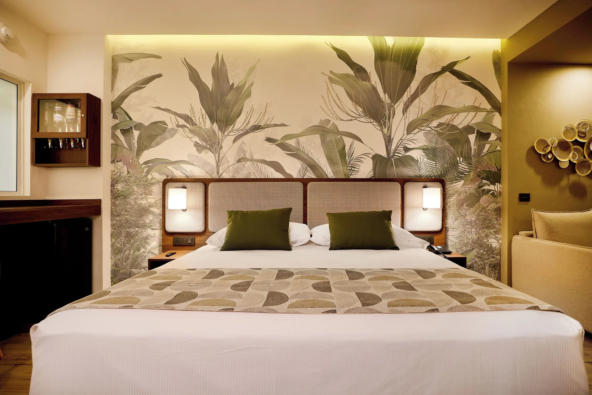 Swim-up adults-only room bed with tropical mural at Hotel Riu Guanacaste.