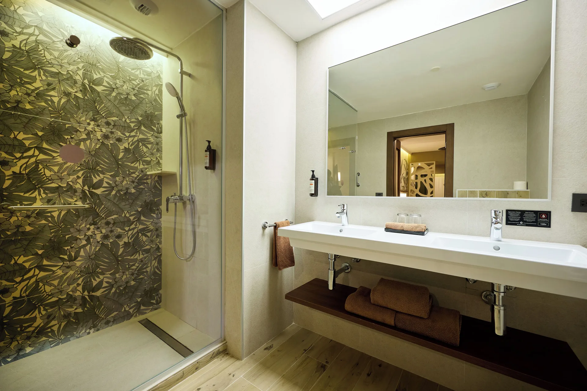 Standard Ocean View bathroom with glass shower and double sink at Hotel Riu Guanacaste.