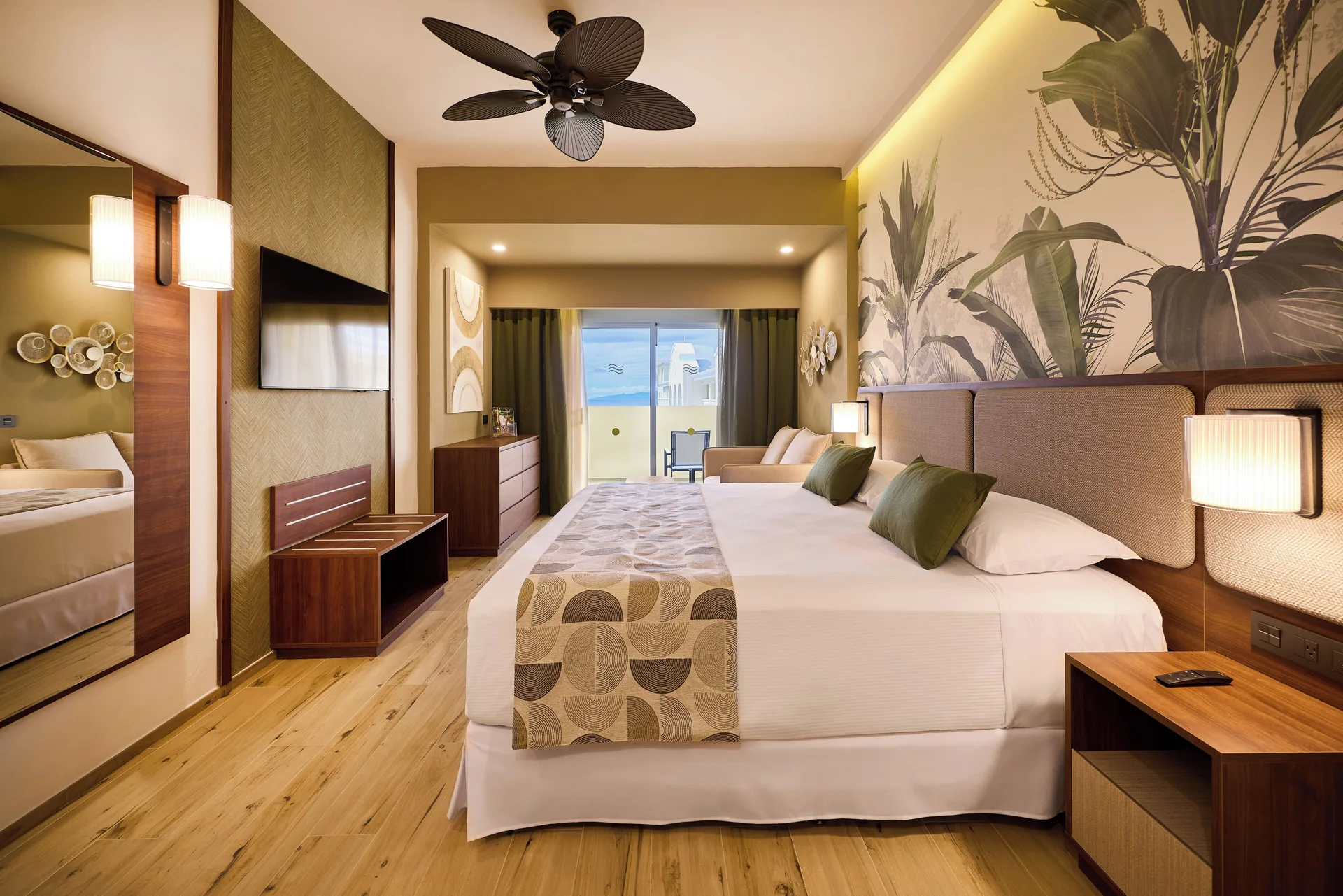 Standard Ocean View room with king bed and balcony beyond at Hotel Riu Guanacaste.