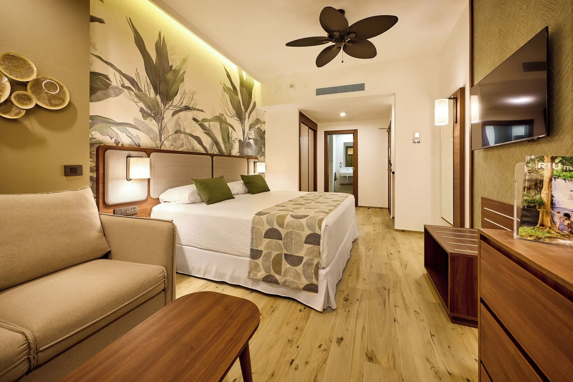 Standard Ocean View room with king bed and sofa at Hotel Riu Guanacaste.