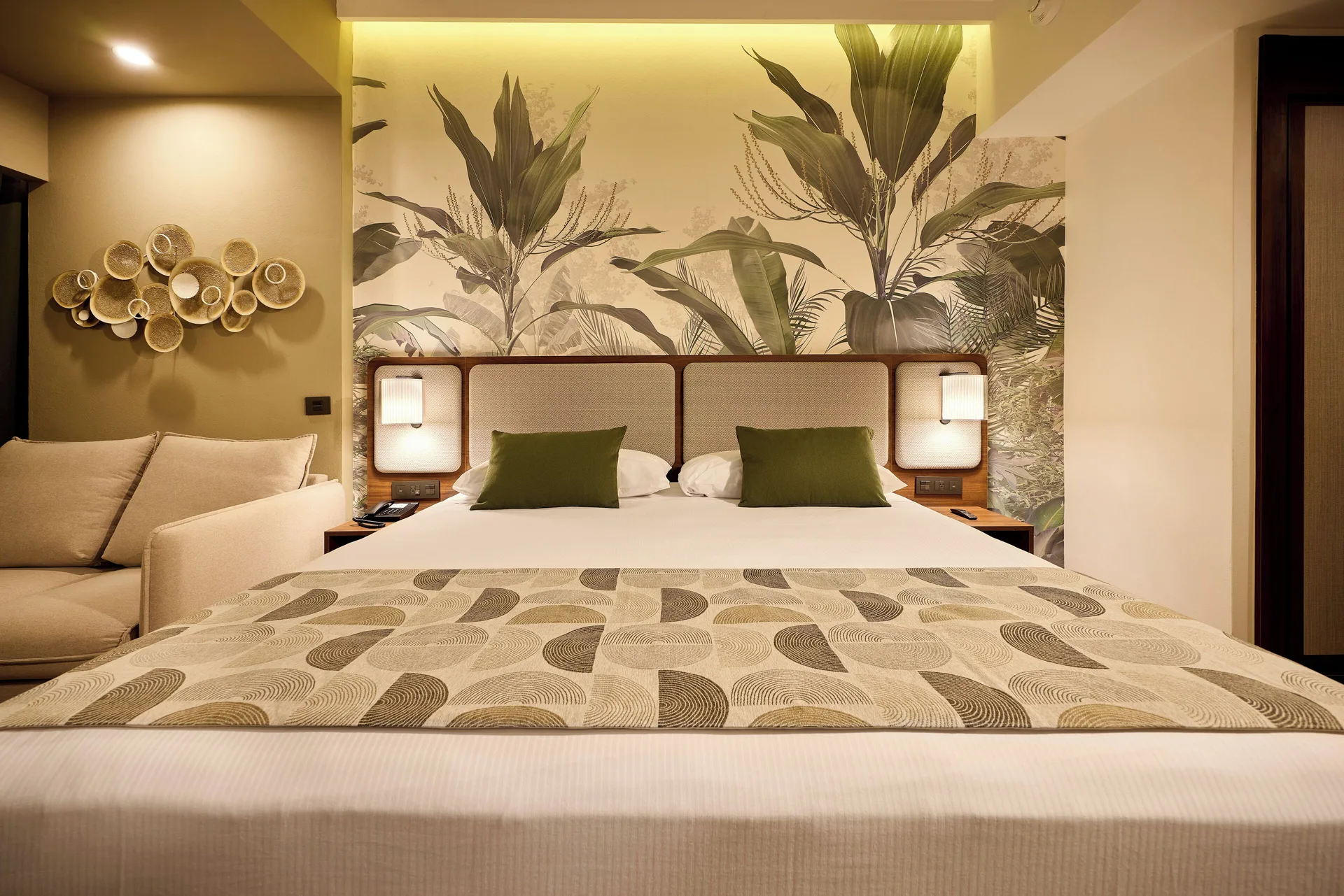 Standard Ocean View king bed with tropical wall mural at Hotel Riu Guanacaste.